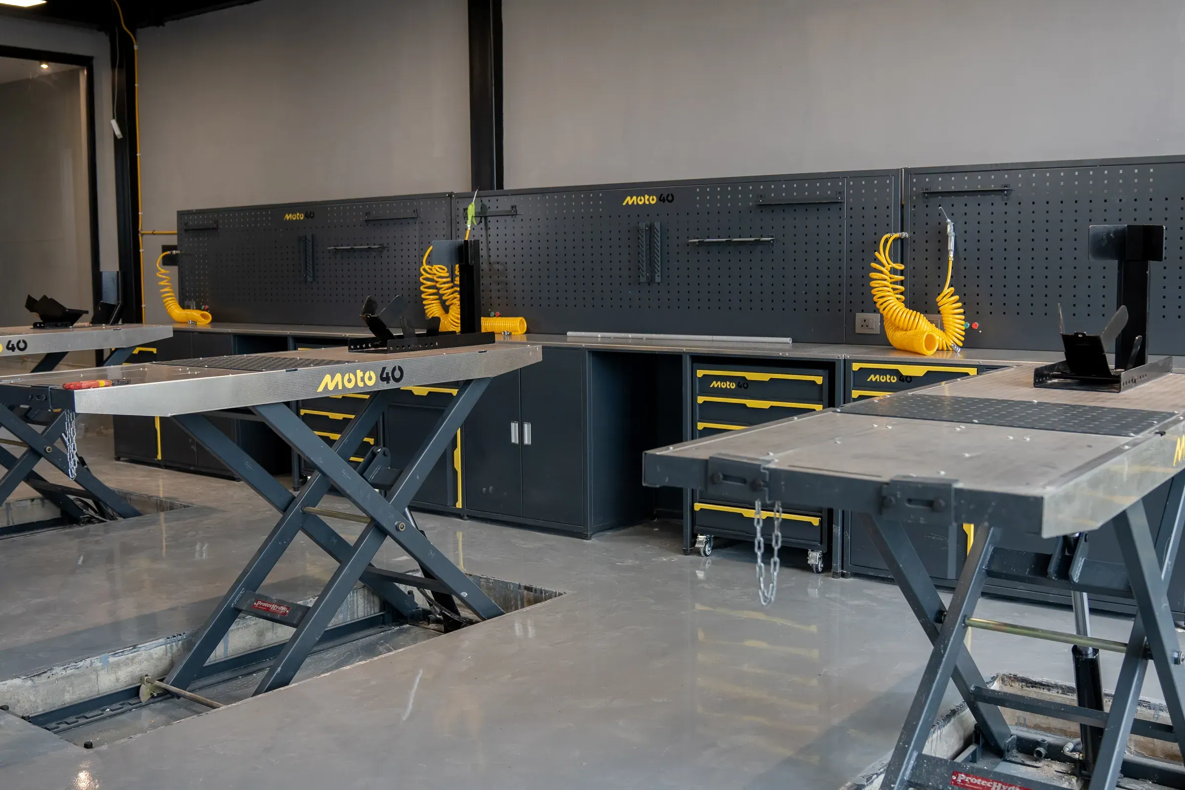 Moto40 workbenches with tool boards and motorcycle lifts