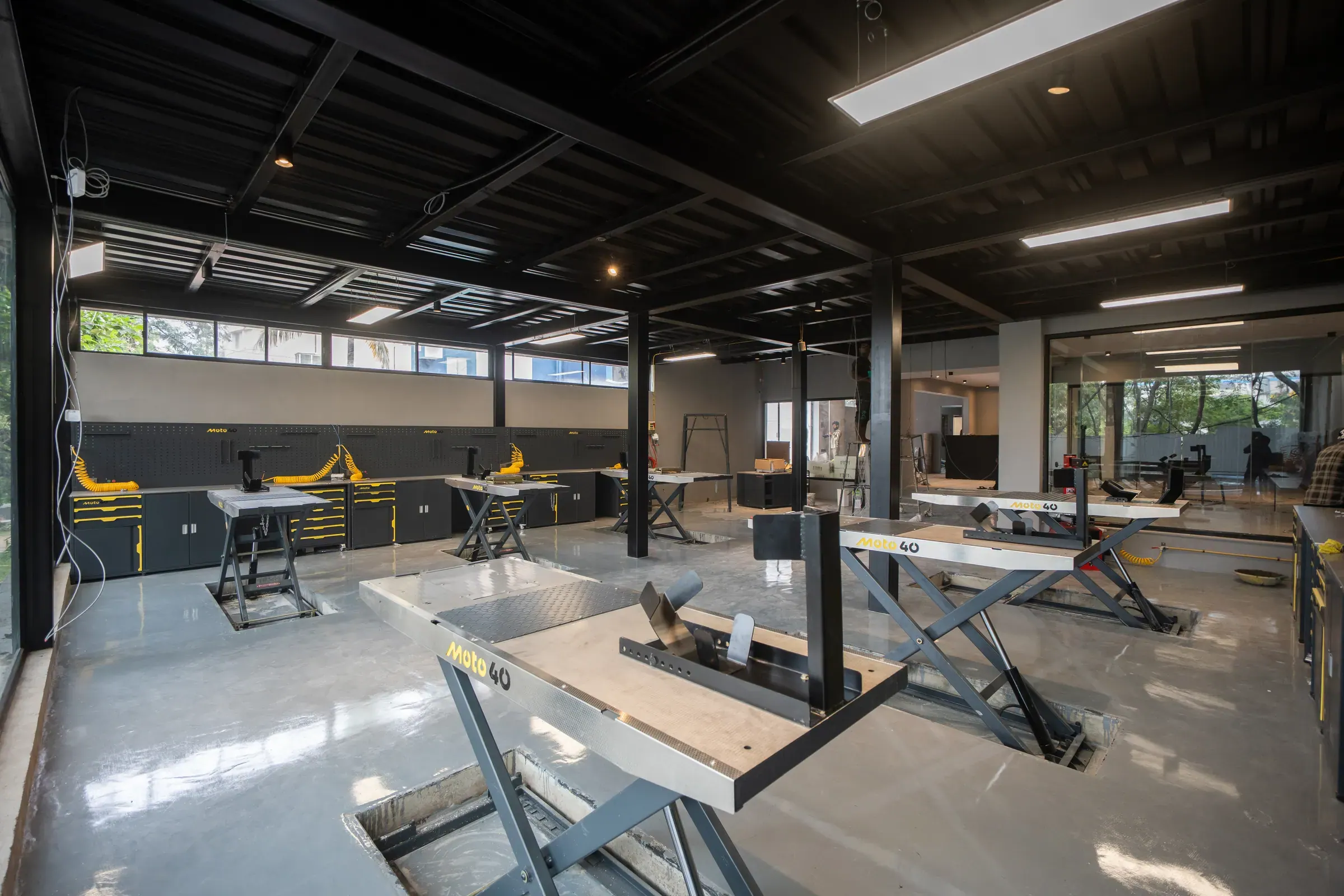 The Moto40 workshop interior with scissor lifts set into the floor